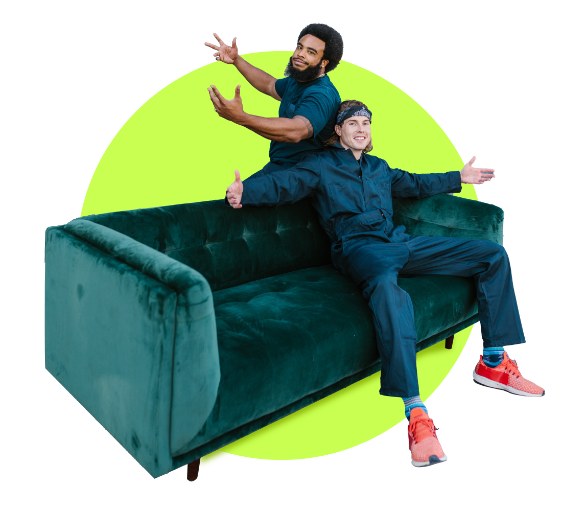 Two moving industry professionals posing on a coutch
